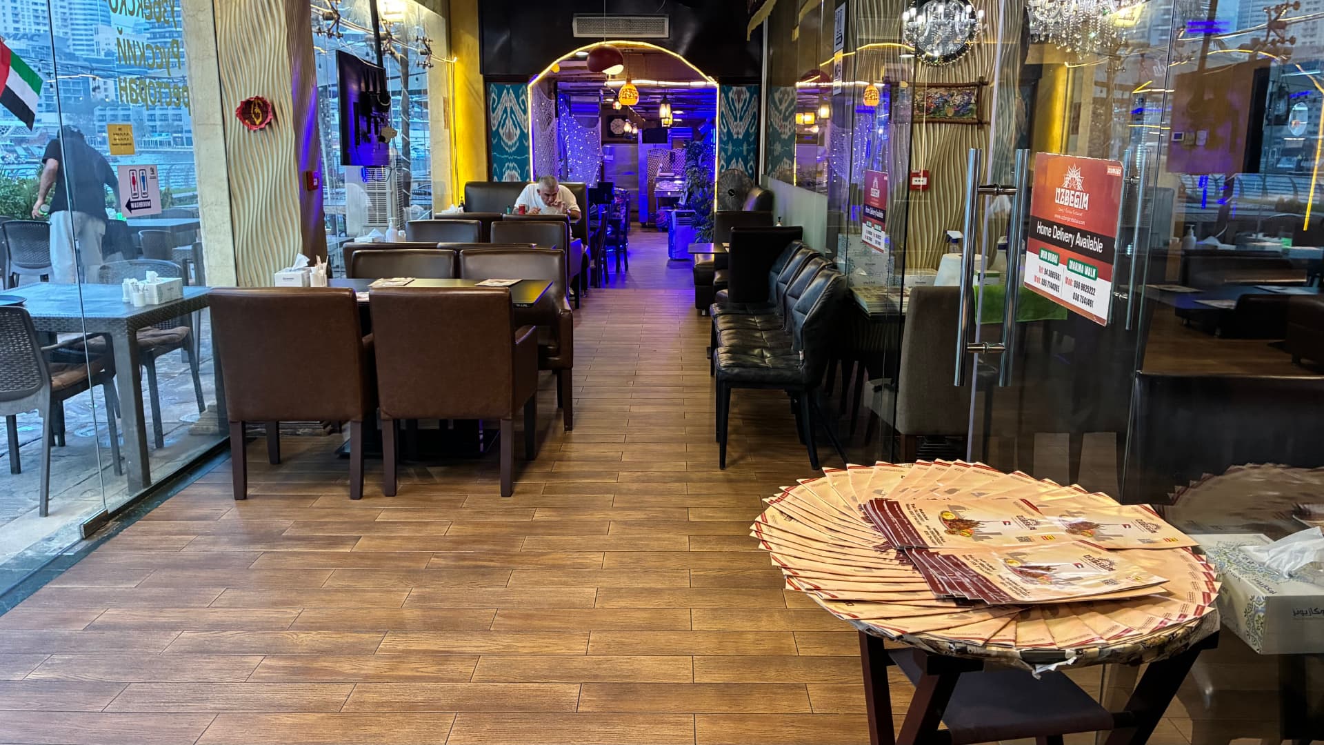 Marina-facing entrance and booth seating at UZBEGIM
