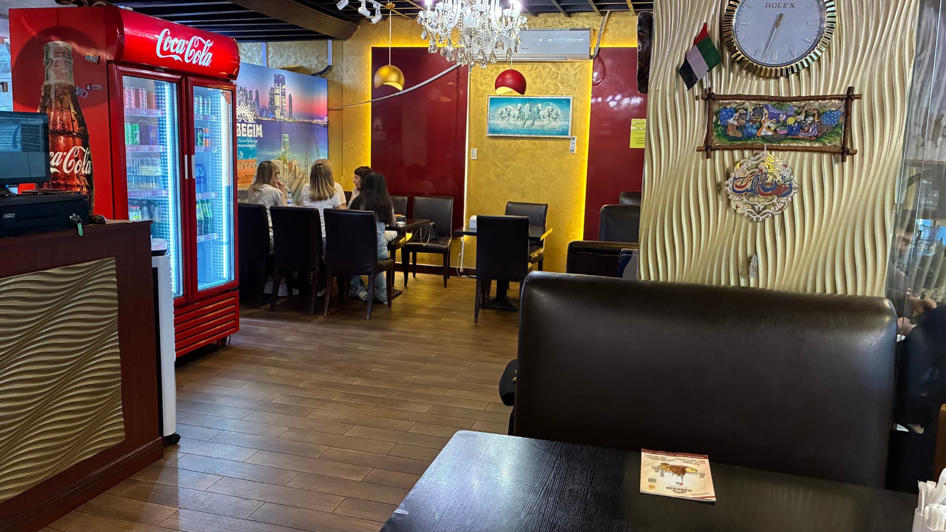 UZBEGIM dining room with chandeliers and leather seating